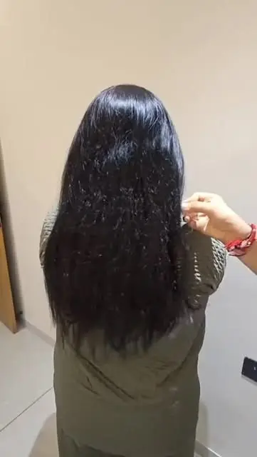 Long, smooth black hair after a hair care appointment, seen from behind